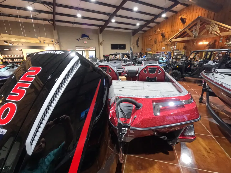 Slide: The Image of 2025 Ranger Z521 boat in showroom, featuring Mercury 250 engine. - 2