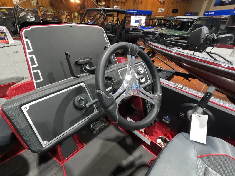 Slide: The Image of 2025 Ranger Z521 boat dashboard with steering wheel and control panel. - 7