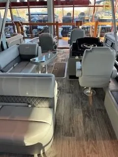 Slide: The Image of 2025 Ranger Reata 223F boat interior with plush seating and modern design. - 1