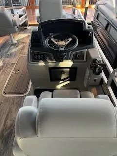 Slide: The Image of 2025 Ranger Reata 223F boat interior with steering console and seating. - 2