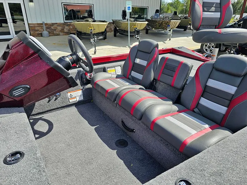 Slide: The Image of 2025 Ranger RT178C boat interior with gray and red seating, steering wheel, and carpeted flooring. - 11