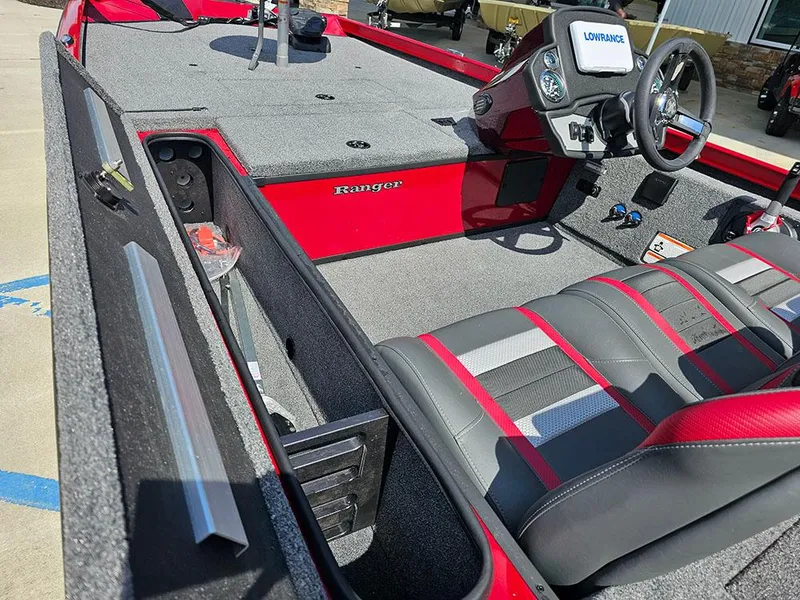 Slide: The Image of 2025 Ranger RT178C boat interior with red accents and modern dashboard. - 13
