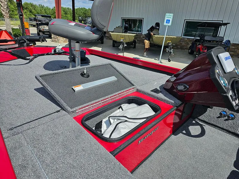 Slide: The Image of 2025 Ranger RT178C boat with open storage compartment and seating, displayed outdoors. - 14