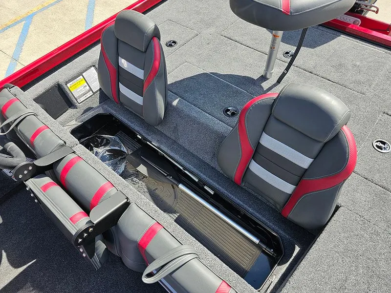 Slide: The Image of 2025 Ranger RT178C boat interior with gray and red seats, storage compartment open. - 18