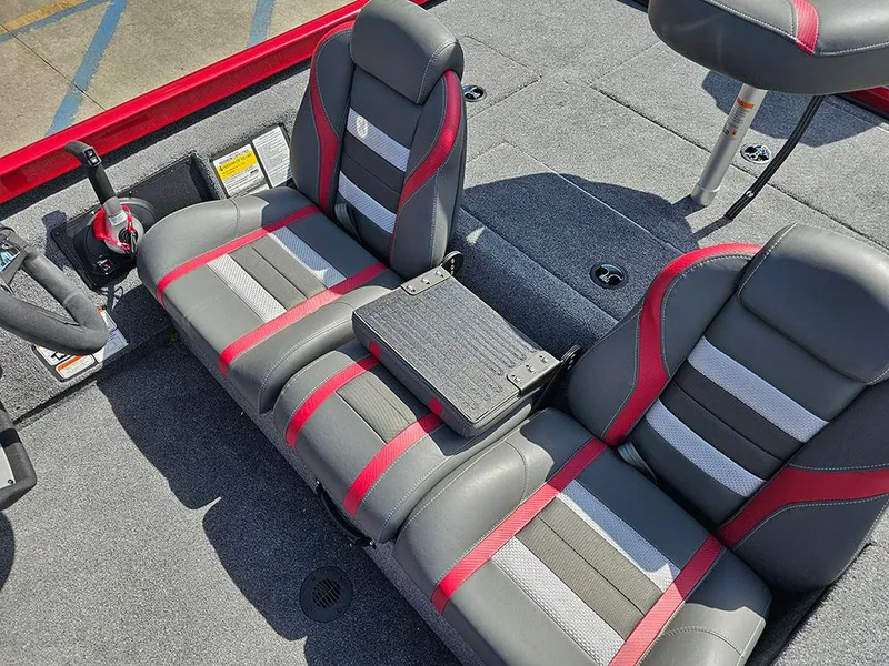 Slide: The Image of 2025 Ranger RT178C boat interior with gray and red seating, steering wheel, and control panel. - 19