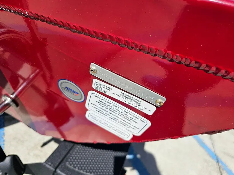 Slide: The Image of 2025 Ranger RT178C boat with identification plate and labels on red exterior. - 26
