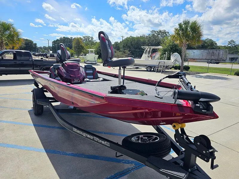 Slide: The Image of 2025 Ranger RT178C boat on trailer, parked outdoors under a blue sky. - 5