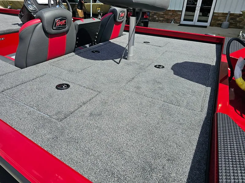 Slide: The Image of 2025 Ranger RT178C boat interior with gray carpet and red-accented seats. - 9