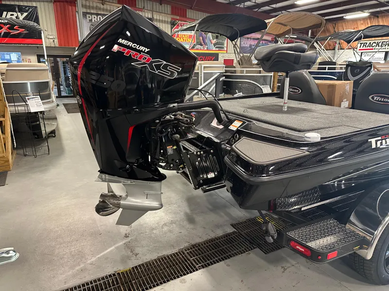 Slide: The Image of Triton 21XP Patriot 2025 boat with Mercury Pro XS engine in showroom. - 3