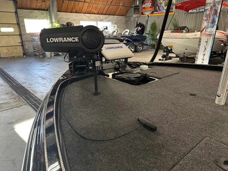Slide: The Image of 2025 Triton 21XP Patriot boat with Lowrance equipment in a showroom. - 5