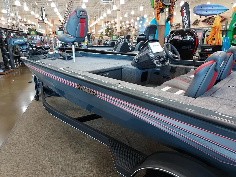 Slide: The Image of 2025 Ranger RT188C fishing boat displayed in a showroom with modern seating and controls. - 1