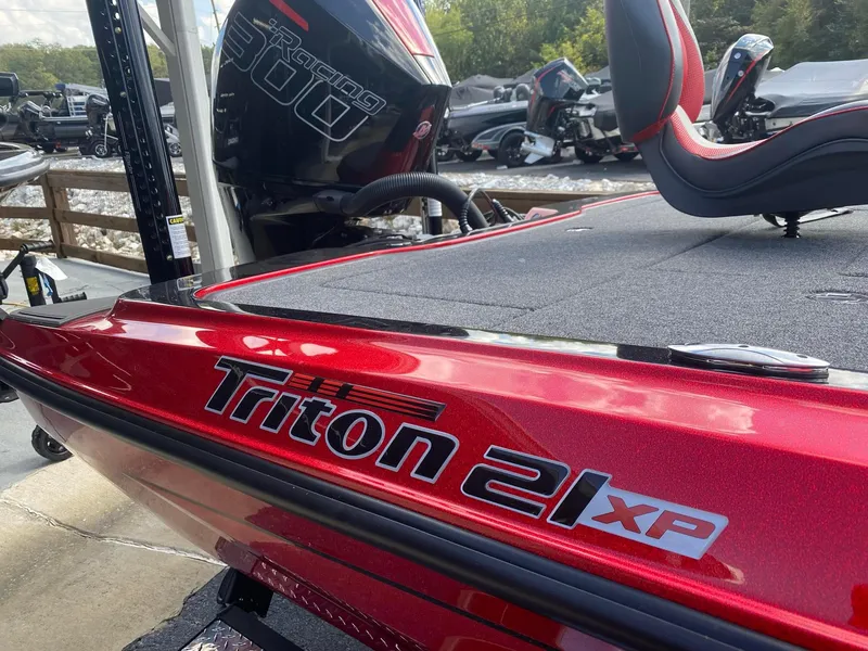 Slide: The Image of 2025 Triton 21XP Patriot boat in vibrant red, featuring sleek design and comfortable seating. - 3