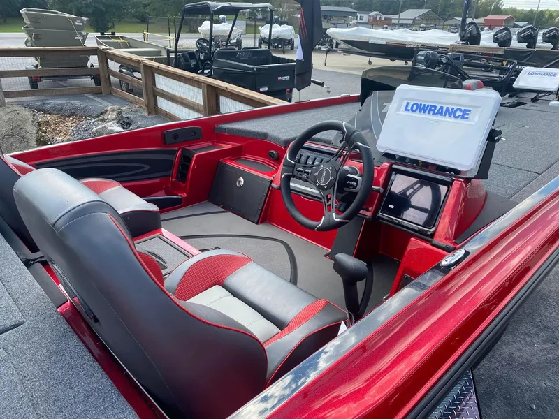 Slide: The Image of 2025 Triton 21XP Patriot boat interior with steering wheel and Lowrance GPS system. - 5