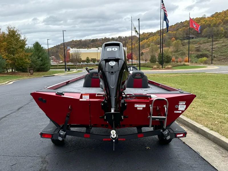Slide: The Image of 2025 Ranger RT178C boat, red, rear view with motor, parked outdoors. - 3
