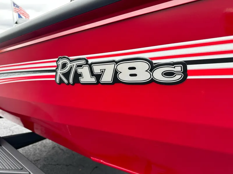Slide: The Image of 2025 Ranger RT178C boat, red with white stripes, close-up view. - 4