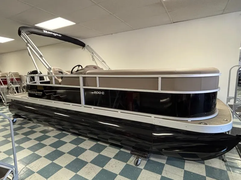 The Image of 2025 Ranger 200C pontoon boat in showroom, featuring sleek black and beige design. - 0