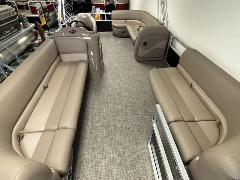 Slide: The Image of 2025 Ranger 200C boat interior with beige seating and carpeted floor. - 2
