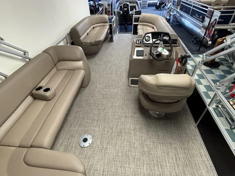 Slide: The Image of 2025 Ranger 200C boat interior with beige seating and modern steering console. - 3