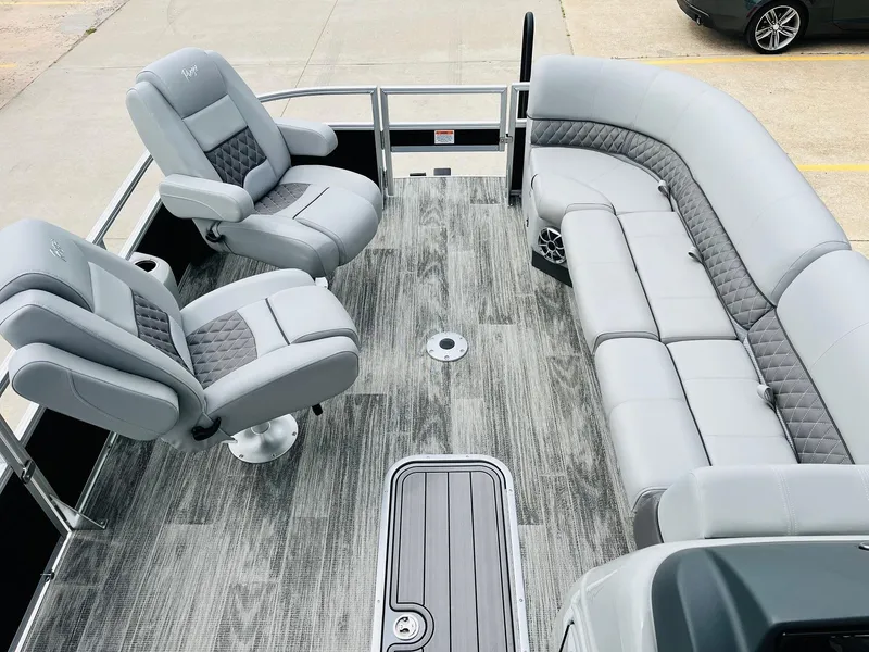 Slide: The Image of 2025 Ranger Reata 223FC boat interior with gray seating and modern design. - 11