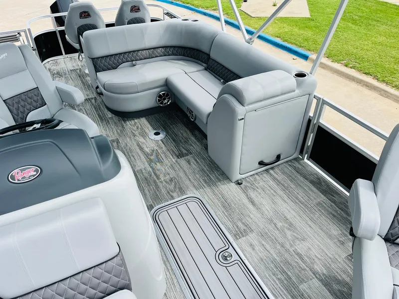 Slide: The Image of 2025 Ranger Reata 223FC boat interior with gray seating and modern design. - 21