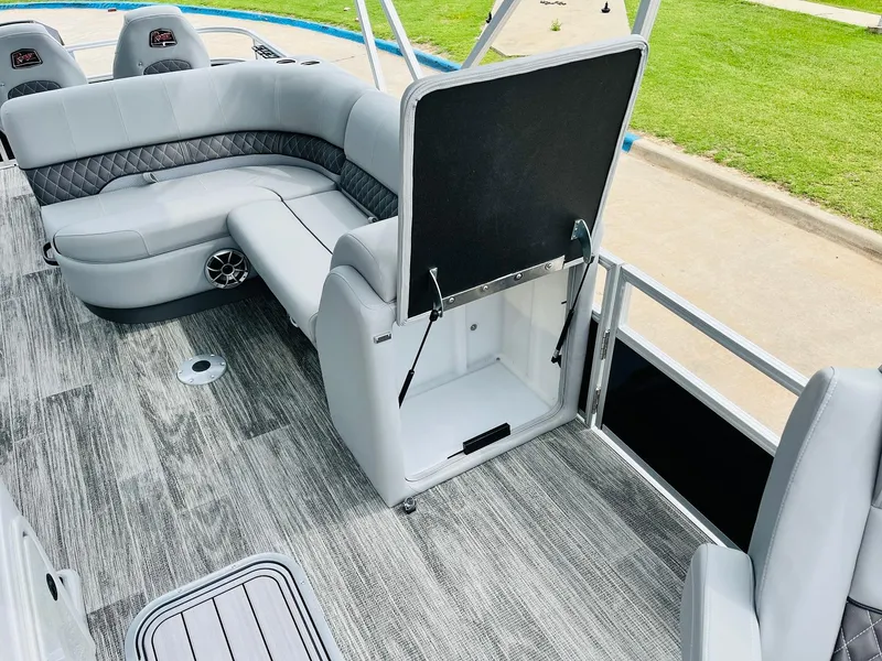 Slide: The Image of 2025 Ranger Reata 223FC boat interior with gray seating and wood-style flooring. - 22
