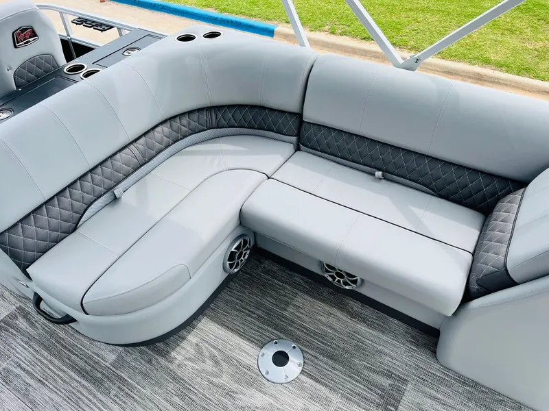 Slide: The Image of 2025 Ranger Reata 223FC boat interior with gray cushioned seating and cup holders. - 23