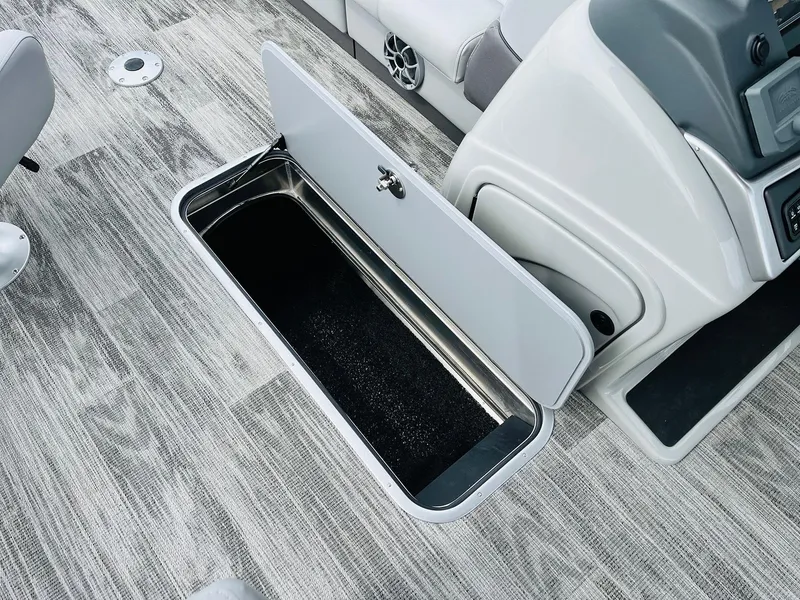 Slide: The Image of 2025 Ranger Reata 223FC boat storage compartment open on deck. - 27