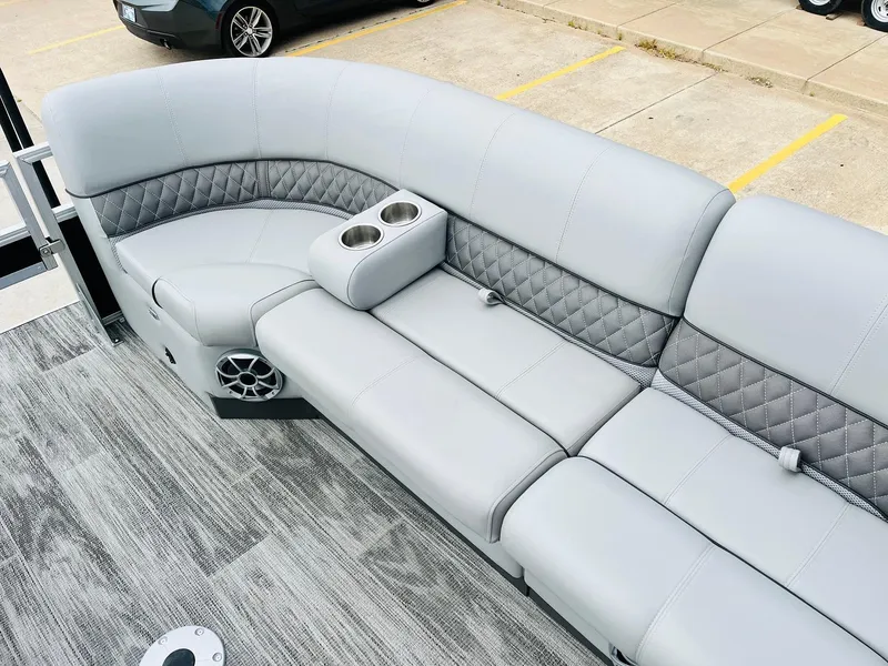 Slide: The Image of 2025 Ranger Reata 223FC boat interior with gray cushioned seating and cup holders. - 29