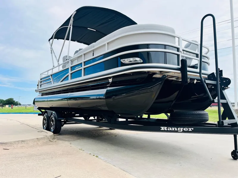 Slide: The Image of 2025 Ranger Reata 223FC pontoon boat on trailer, featuring sleek design and canopy. - 3