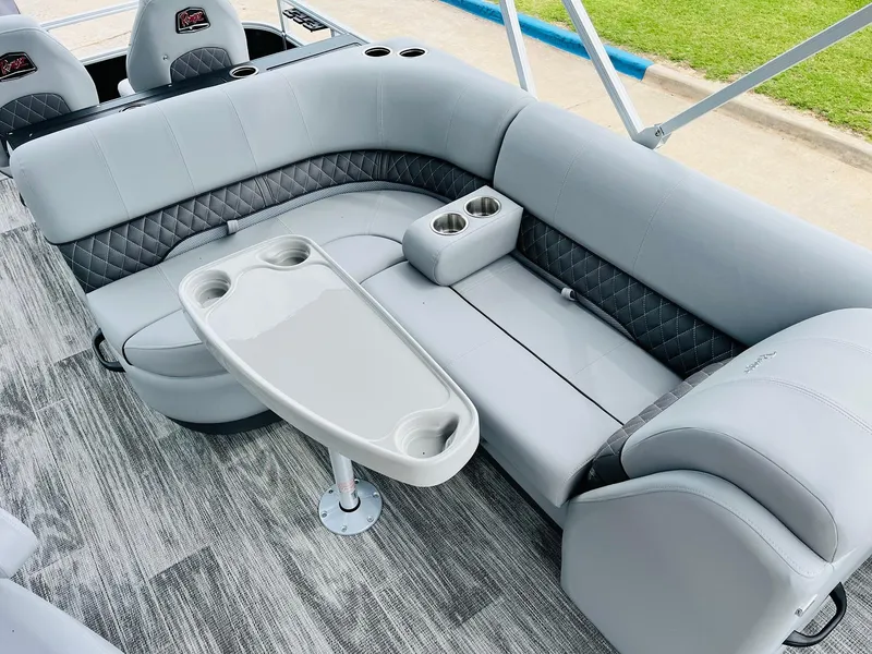 Slide: The Image of 2025 Ranger Reata 223FC boat interior with gray seating and table. - 30