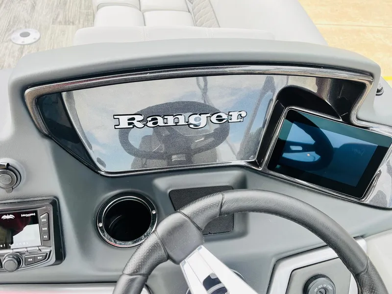 Slide: The Image of 2025 Ranger Reata 223FC dashboard with steering wheel and digital display. - 35