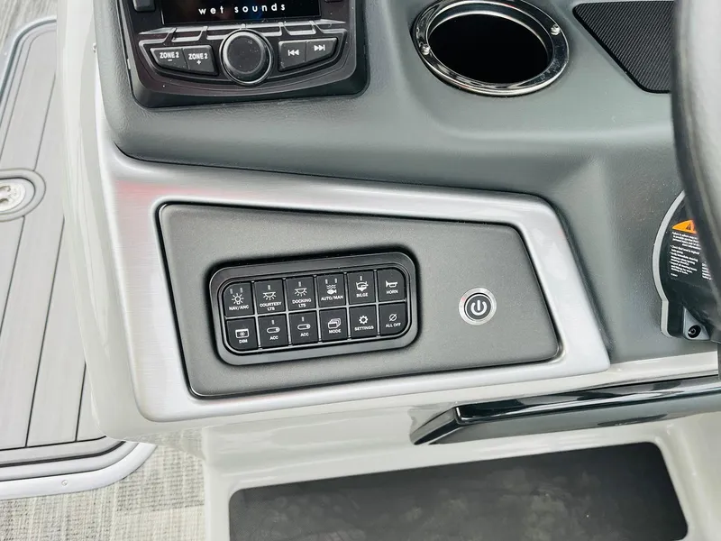 Slide: The Image of Control panel of 2025 Ranger Reata 223FC boat with buttons and cup holder. - 37