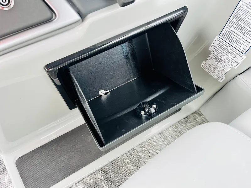 Slide: The Image of Open storage compartment in 2025 Ranger Reata 223FC boat interior. - 38