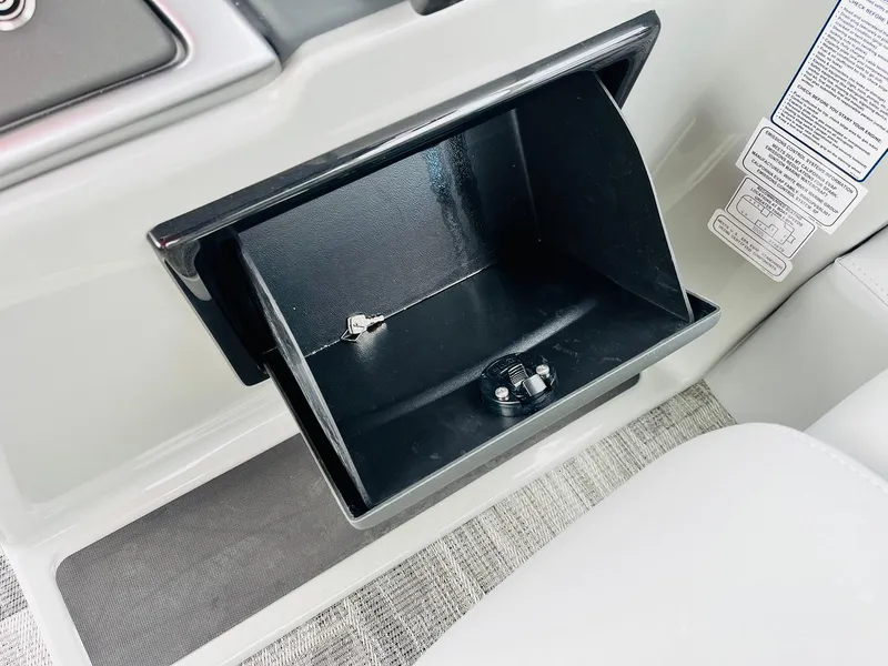 Slide: The Image of Open storage compartment in 2025 Ranger Reata 223FC boat interior. - 39