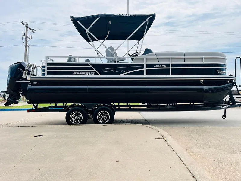 Slide: The Image of 2025 Ranger Reata 223FC pontoon boat with canopy on trailer. - 4