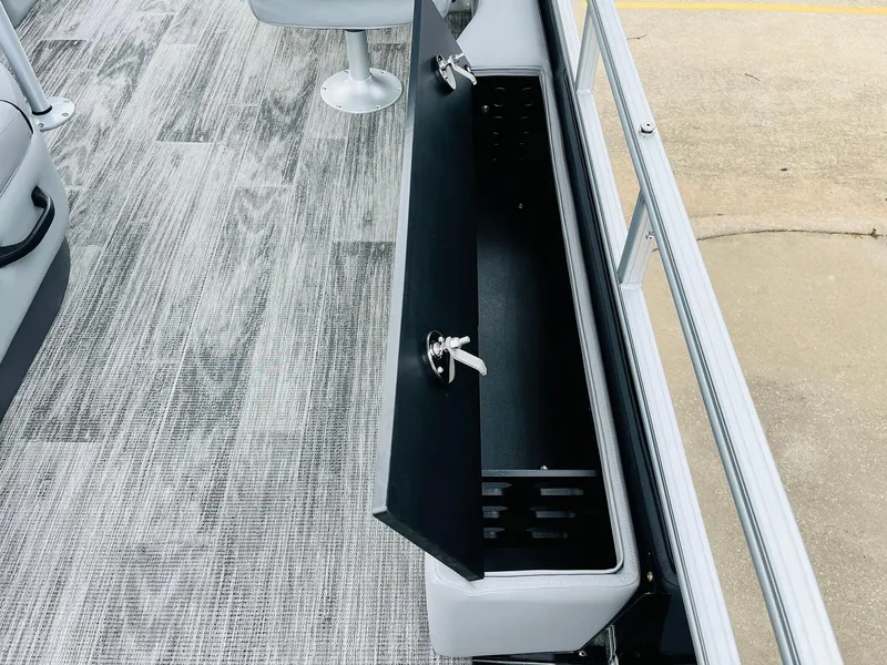 Slide: The Image of 2025 Ranger Reata 223FC boat interior with open storage compartment and seating. - 47