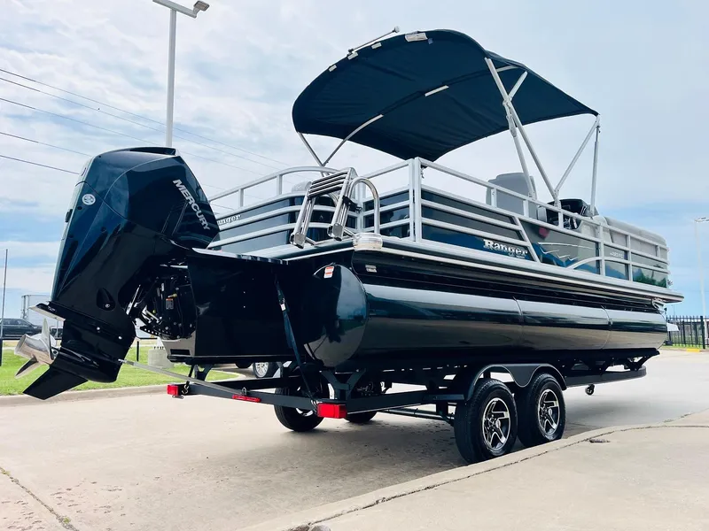 Slide: The Image of 2025 Ranger Reata 223FC pontoon boat with canopy and powerful outboard motor. - 5