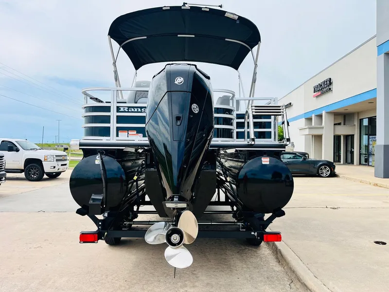 Slide: The Image of 2025 Ranger Reata 223FC boat with outboard motor, parked outside dealership. - 6