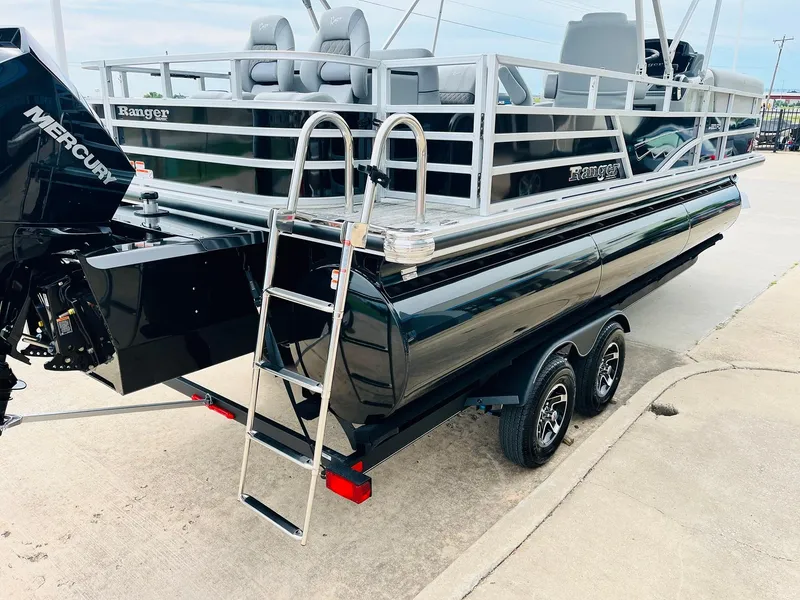 Slide: The Image of 2025 Ranger Reata 223FC boat on trailer with ladder and Mercury engine. - 8