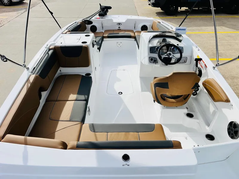 Slide: The Image of 2025 Tahoe 2150 boat interior with tan and black seating, modern steering console. - 10