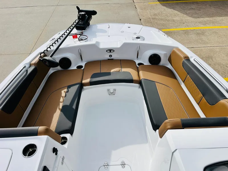 Slide: The Image of 2025 Tahoe 2150 boat interior with tan and black seating, featuring a sleek design. - 11