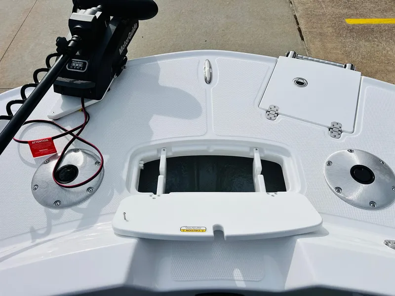 Slide: The Image of 2025 Tahoe 2150 boat deck with storage compartments and fishing rod holders. - 15