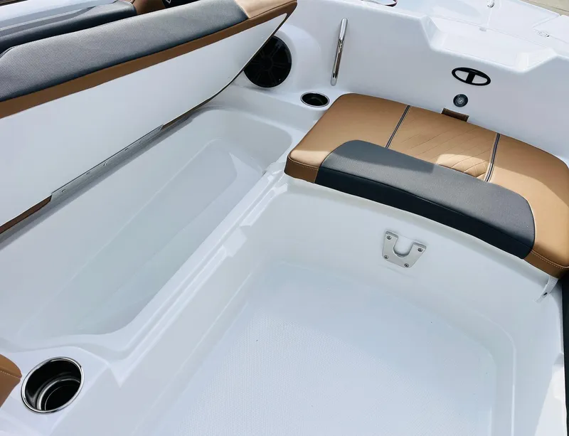 Slide: The Image of 2025 Tahoe 2150 boat interior with cushioned seating and storage compartments. - 16