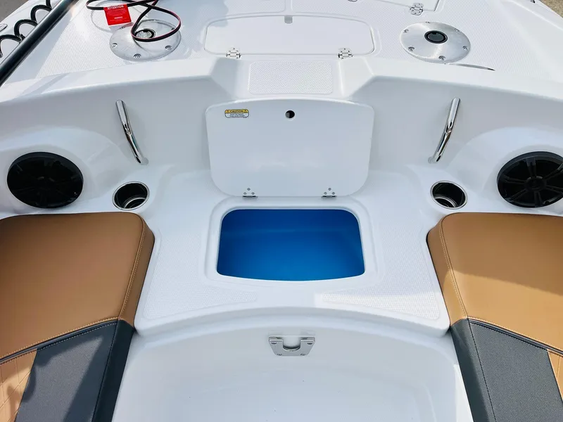 Slide: The Image of 2025 Tahoe 2150 boat interior with storage compartment and seating. - 19