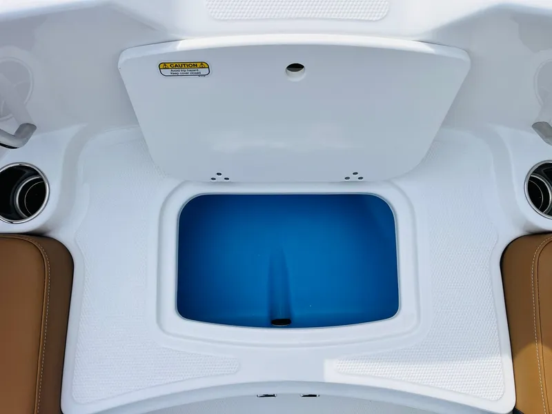 Slide: The Image of 2025 Tahoe 2150 boat interior with storage compartment and cup holders. - 20
