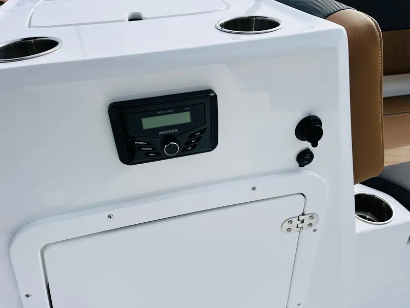 Slide: The Image of 2025 Tahoe 2150 boat console with stereo system and cup holders. - 22