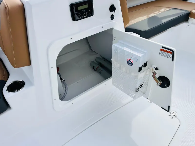 Slide: The Image of 2025 Tahoe 2150 boat storage compartment with open hatch and seating area. - 23