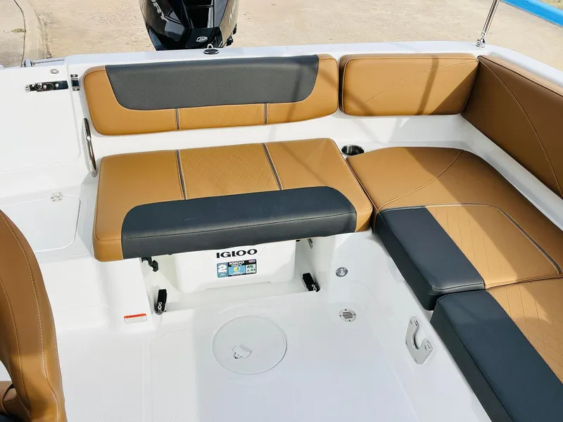 Slide: The Image of 2025 Tahoe 2150 boat interior with tan and black seating, Igloo cooler storage. - 29