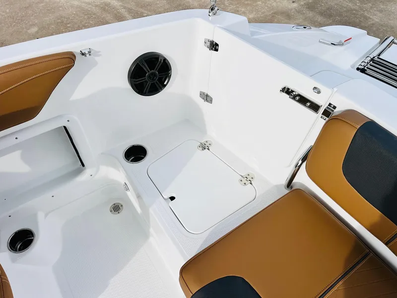 Slide: The Image of 2025 Tahoe 2150 boat interior with brown seating and storage compartments. - 31