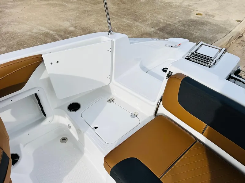 Slide: The Image of Interior of 2025 Tahoe 2150 boat with brown and black seating. - 32